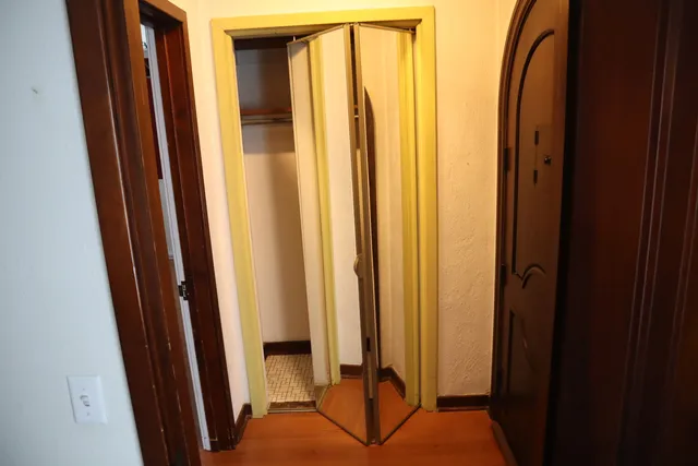 a view of a bathroom with mirror and a sink