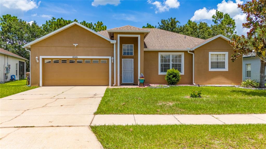 4548 Ficus Tree Road Kissimmee, FL 34758 - Photo 1 of 1 a front view of a house with a garden