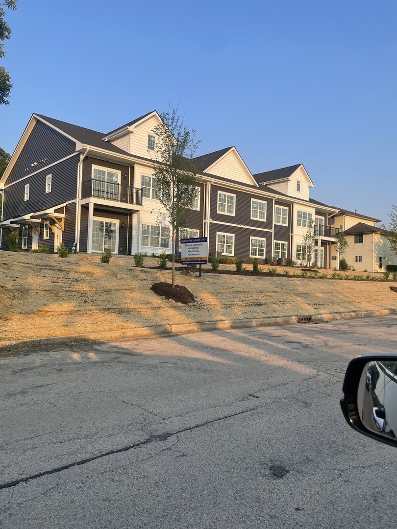 30 South 14th Street, Unit E St. Charles, IL 60174 - Photo 1 of 10 a front view of a house with a yard