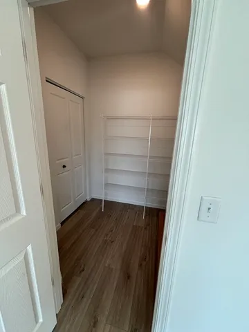 a view of walk in closet with empty racks