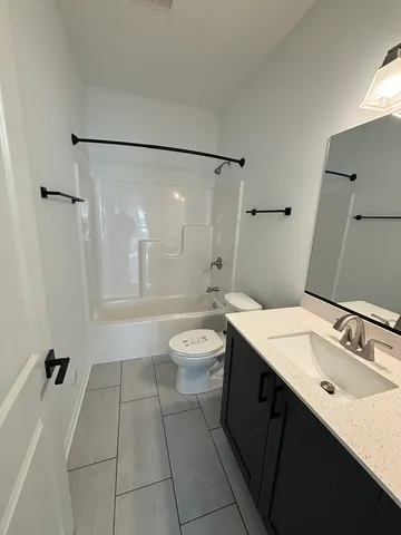 a bathroom with a double vanity sink toilet mirror and shower
