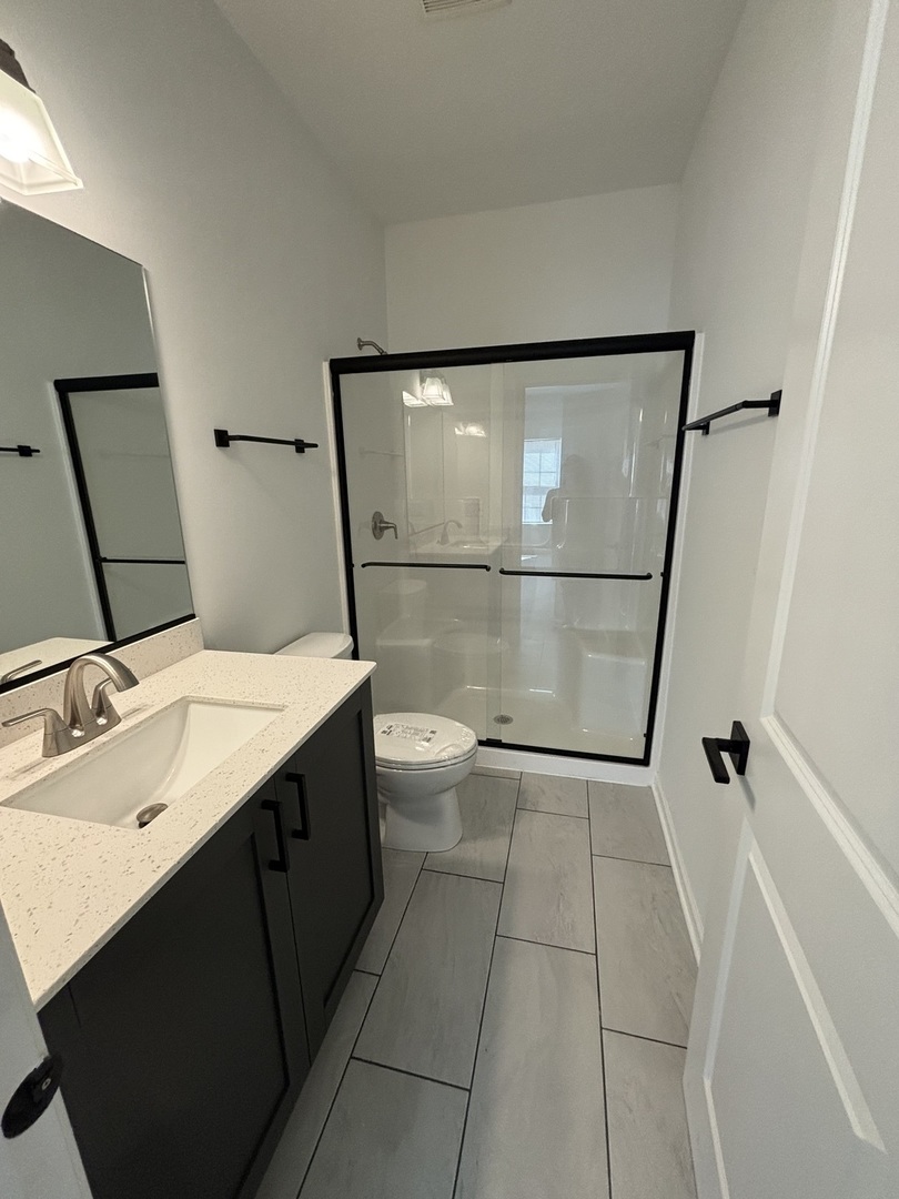 30 South 14th Street, Unit E St. Charles, IL 60174 - Photo 10 of 10 a bathroom with a sink and mirror