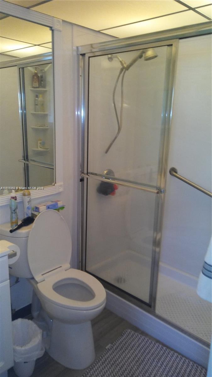 134 Monaco Court, Unit 134 Delray Beach, FL 33446 - Photo 3 of 10 a white toilet sitting next to a shower