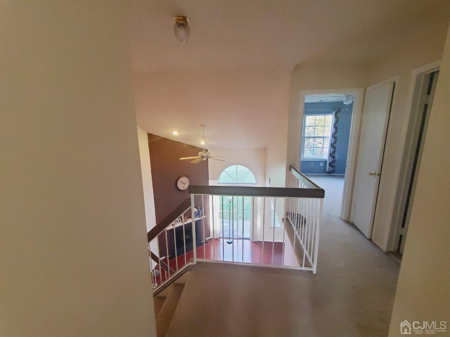 148 Nebula Road Piscataway, NJ 08854 - Photo 1 of 22 a view of staircase with lots of frames on wall and a window