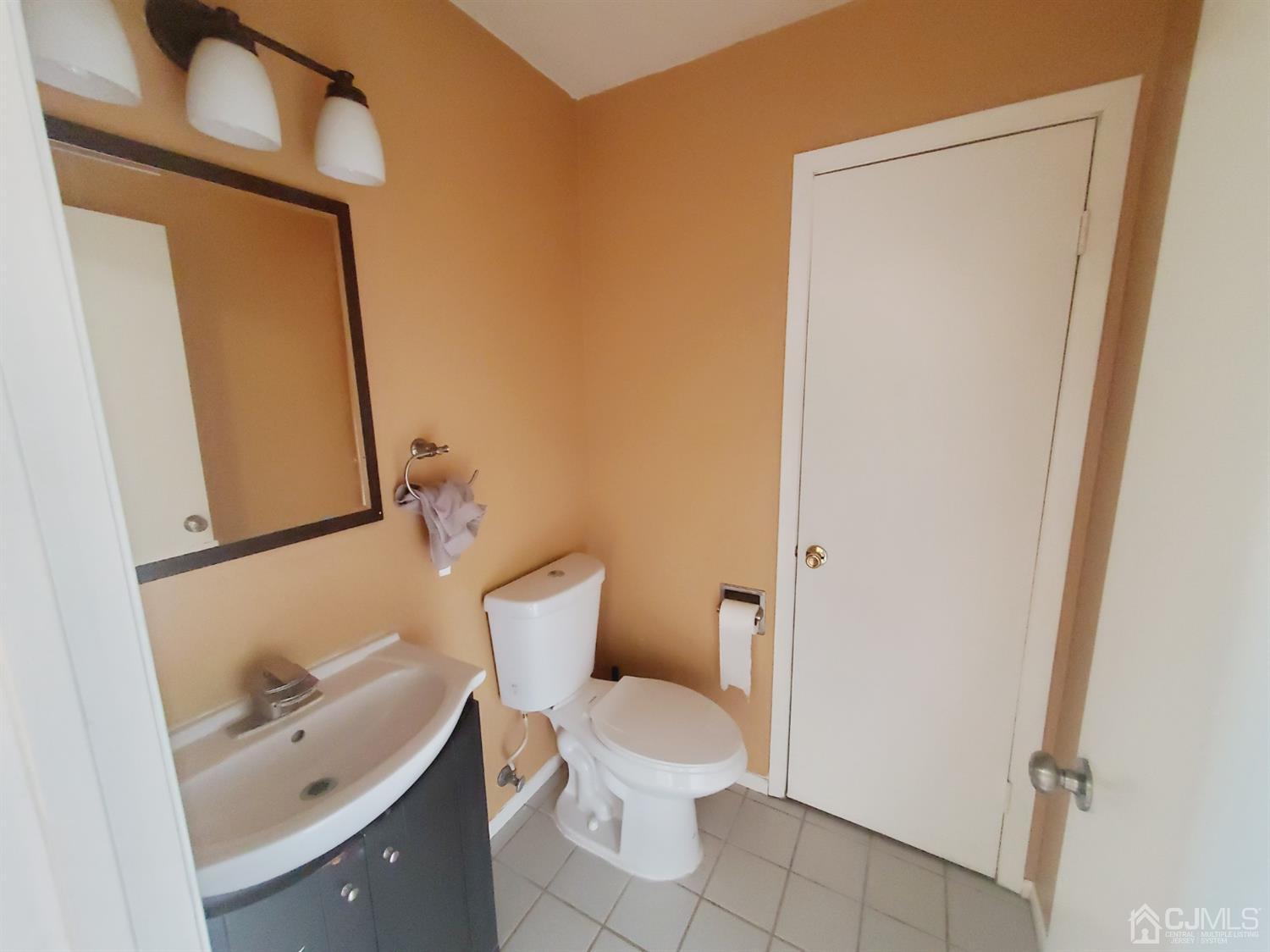 148 Nebula Road Piscataway, NJ 08854 - Photo 11 of 22 a white toilet sitting next to a bathroom sink