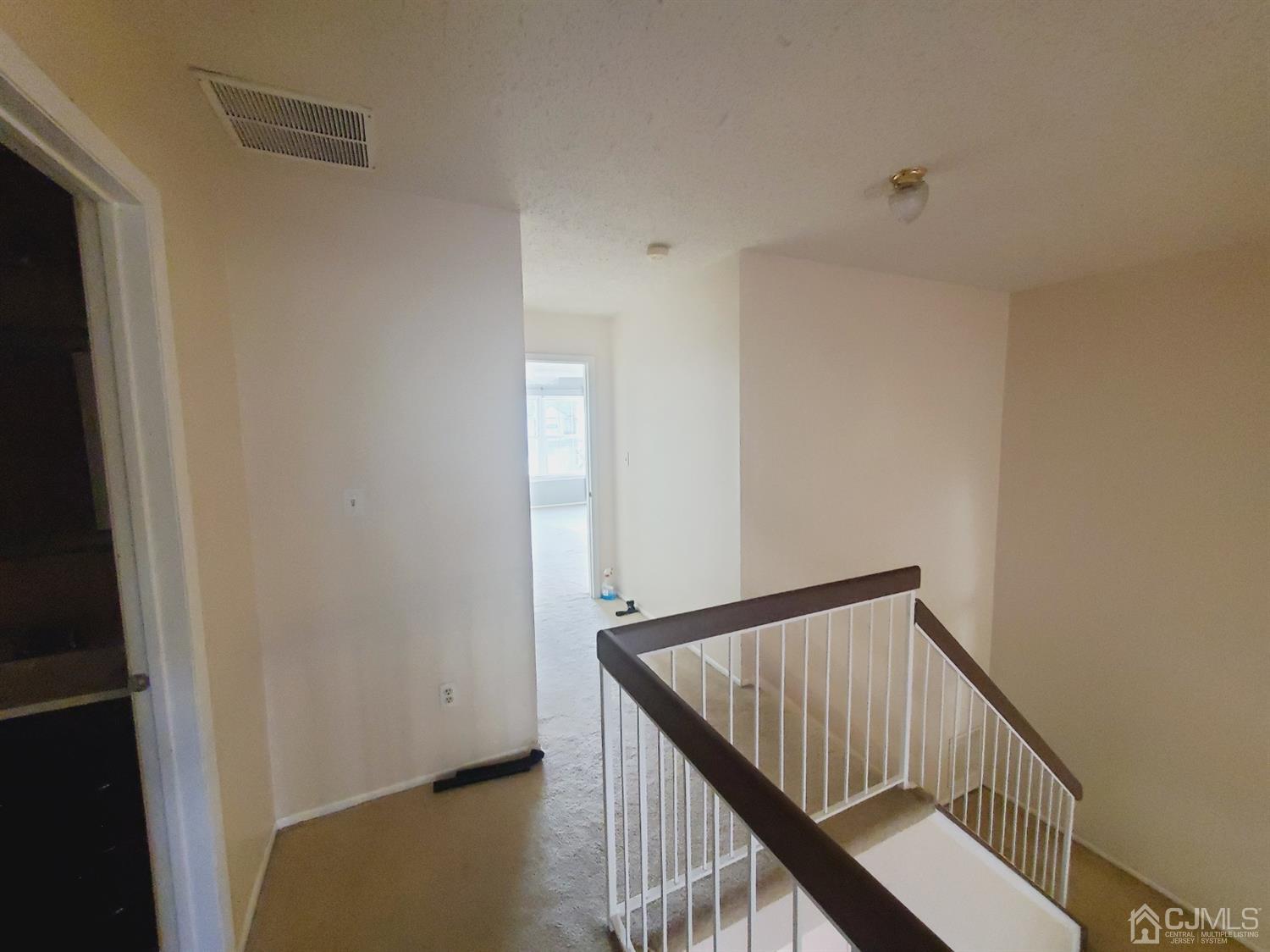 148 Nebula Road Piscataway, NJ 08854 - Photo 12 of 22 a view of staircase with railing and white walls