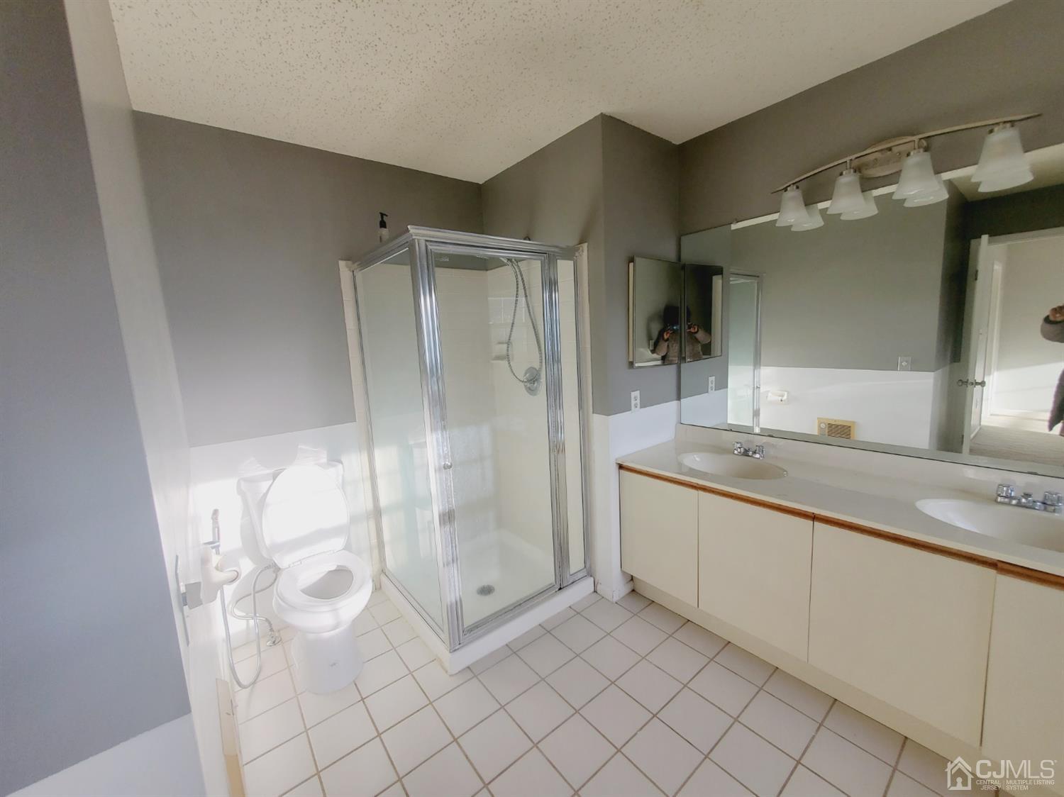 148 Nebula Road Piscataway, NJ 08854 - Photo 4 of 22 a bathroom with a granite countertop sink a mirror and a shower