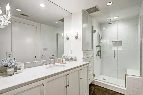 a bathroom with a shower sink double and mirror