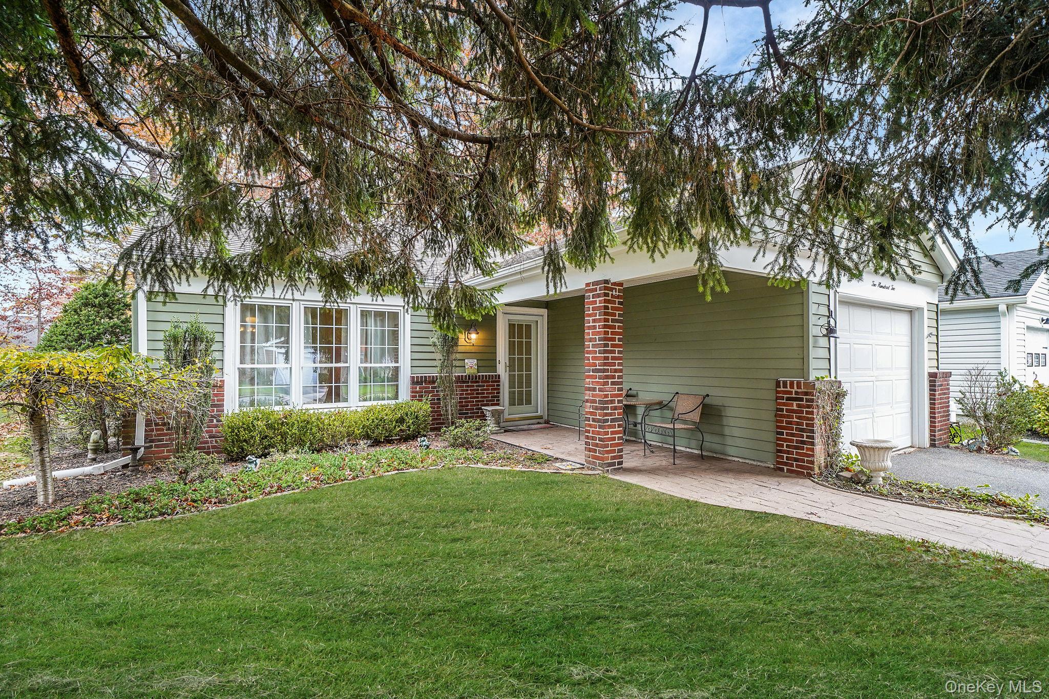 202 Belfast Lane Ridge, NY 11961 - Photo 1 of 1 front view of a house with a yard and a large tree