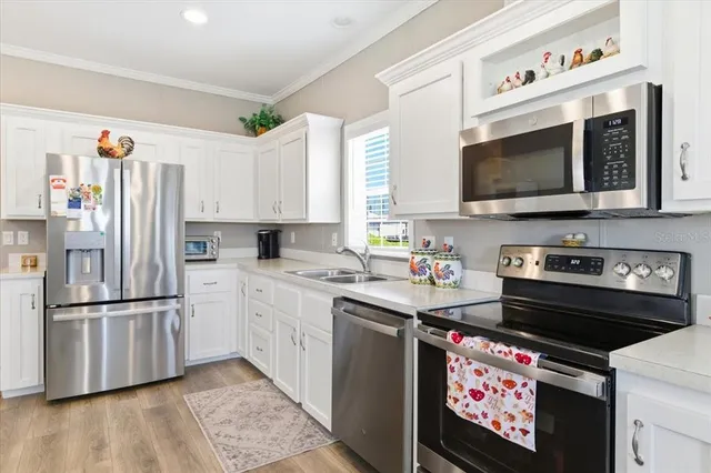 a kitchen with stainless steel appliances a stove a microwave and a refrigerator