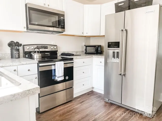 a kitchen with stainless steel appliances a refrigerator stove and sink