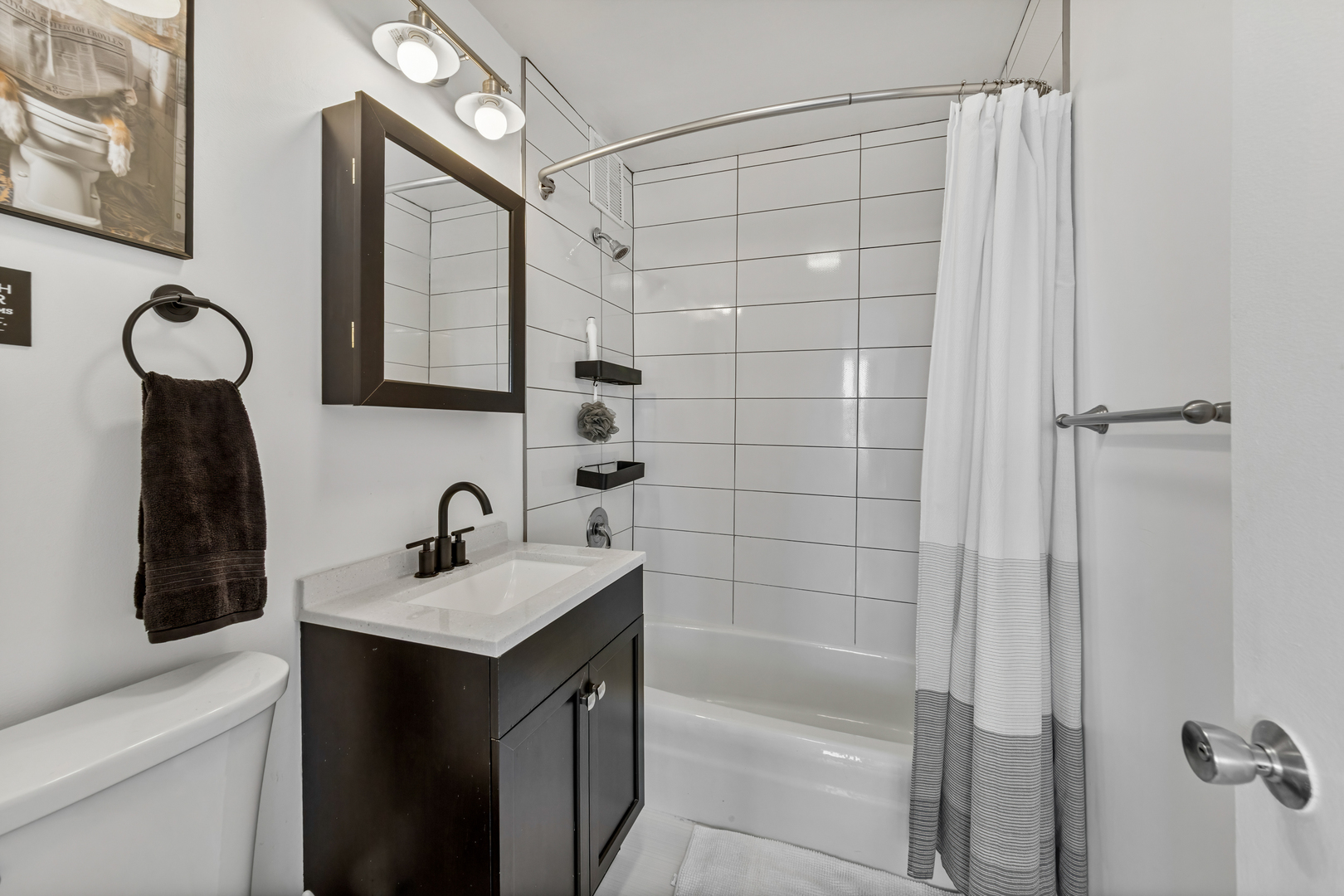 655 West Irving Park Road, Unit 1301 Chicago, IL 60613 - Photo 14 of 22 a bathroom with a sink vanity toilet and shower