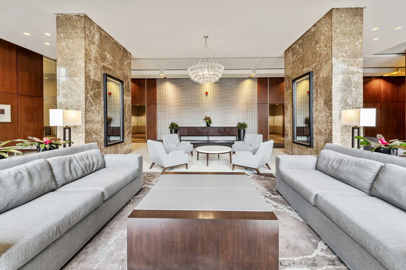 655 West Irving Park Road, Unit 1301 Chicago, IL 60613 - Photo 21 of 22 a living room with furniture and a chandelier