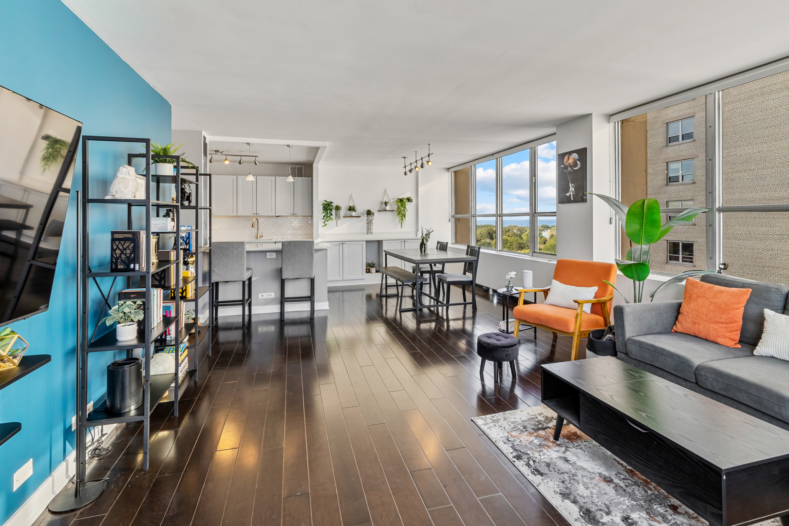 655 West Irving Park Road, Unit 1301 Chicago, IL 60613 - Photo 3 of 22 a living room with furniture and wooden floor