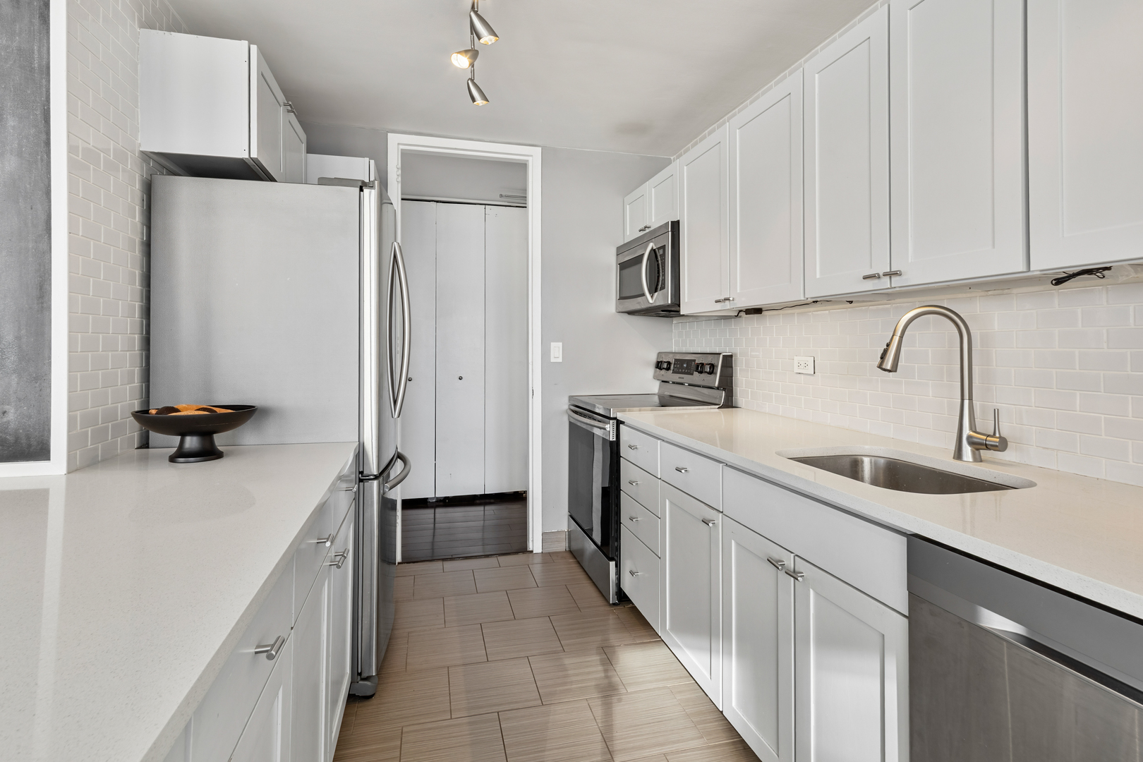 655 West Irving Park Road, Unit 1301 Chicago, IL 60613 - Photo 6 of 22 a kitchen with a sink appliances and cabinets