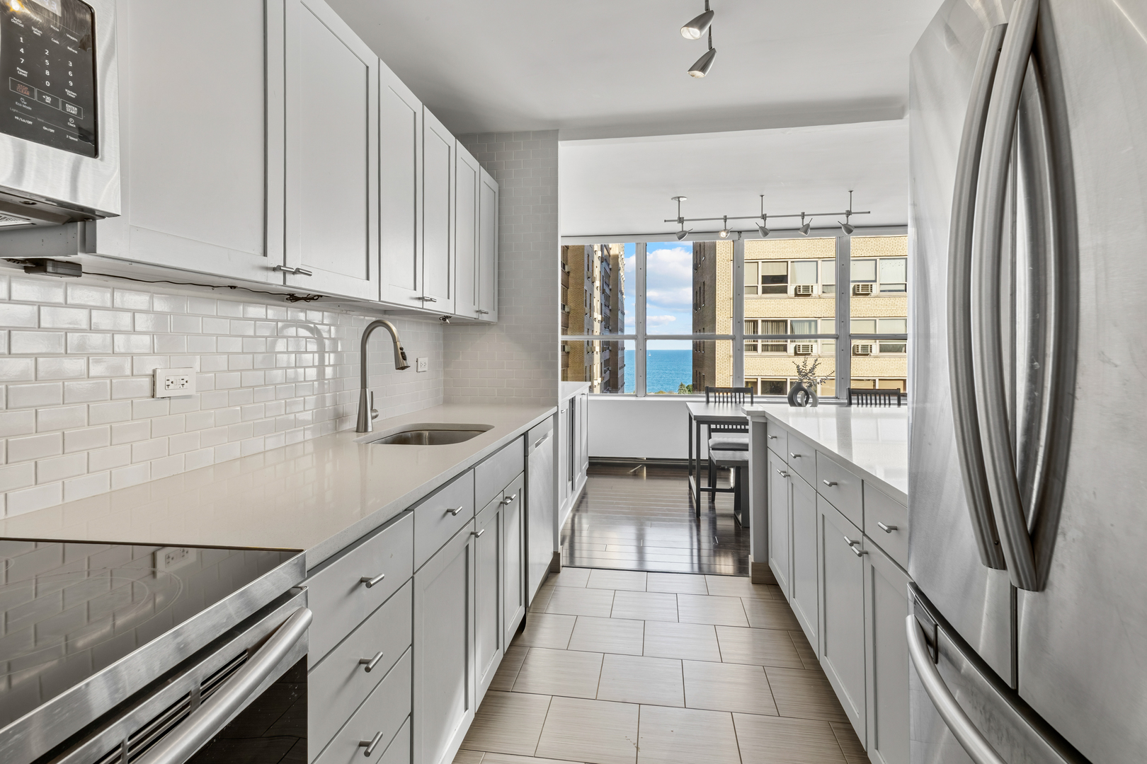 655 West Irving Park Road, Unit 1301 Chicago, IL 60613 - Photo 7 of 22 a kitchen with stainless steel appliances granite countertop a refrigerator and a sink