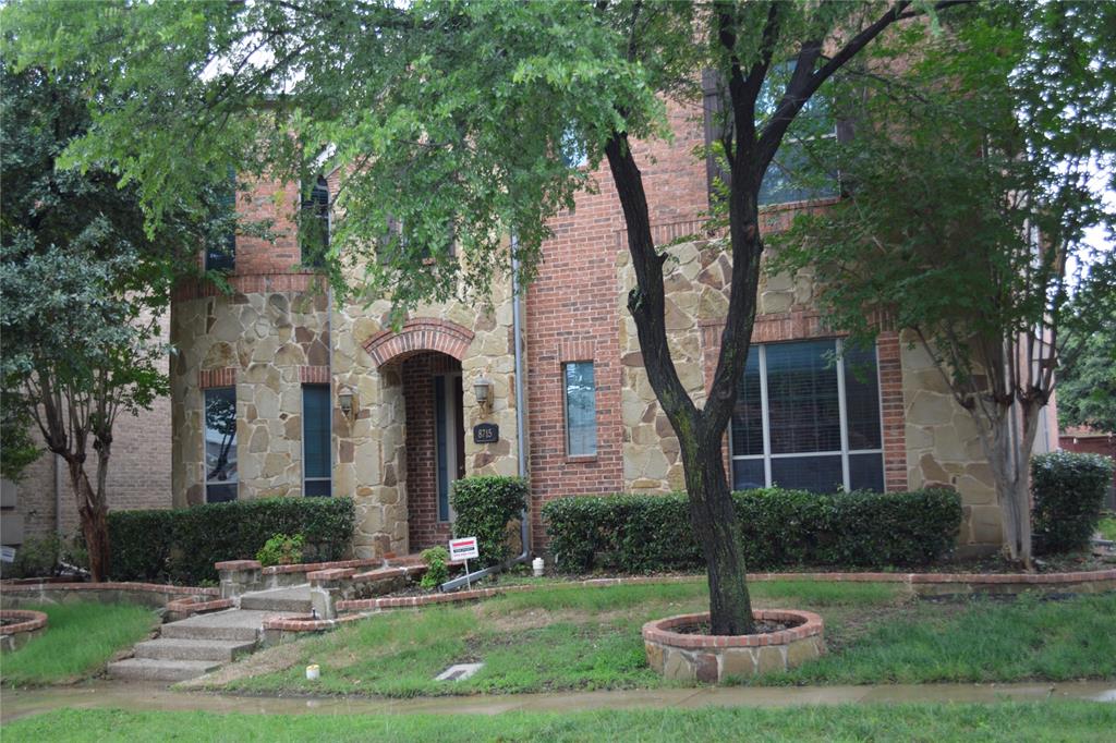 8715 Lost Canyon Road Irving, TX 75063 - Photo 3 of 4 Brick and stone exterior featuring an arched entryway
