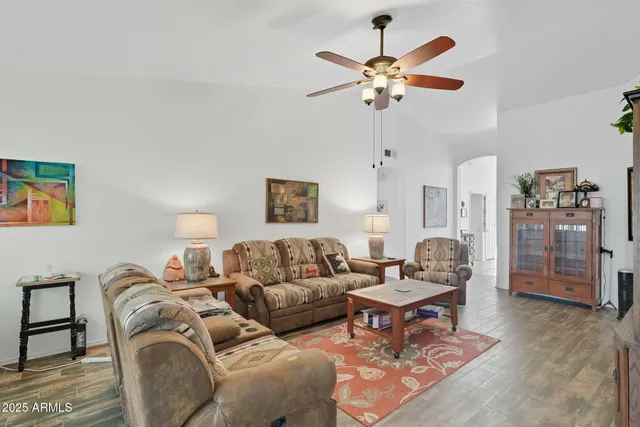 a living room with furniture and a chandelier