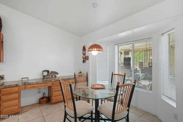 a view of a dining room with furniture and window