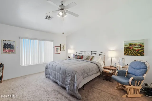 a bed room with a bed and a chair