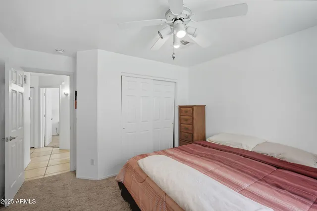 a living room with furniture a ceiling fan and a window