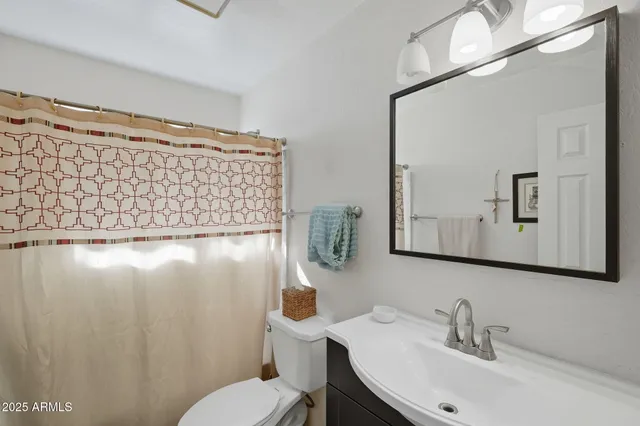 a living room with furniture a ceiling fan and a window