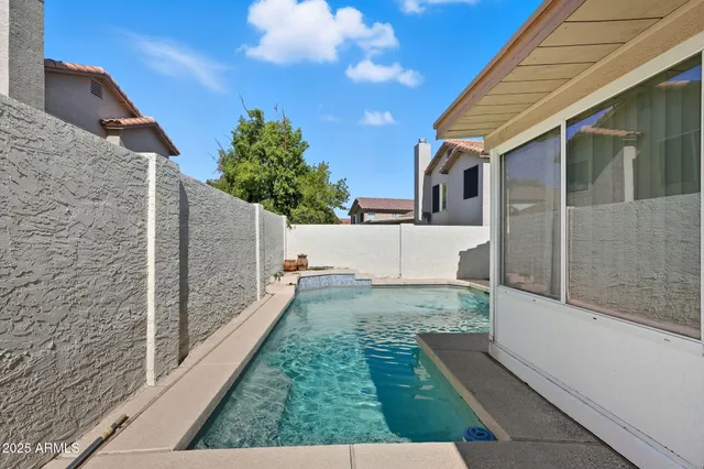 a view of a backyard with a garden and entertaining space
