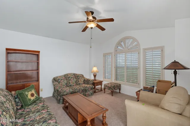 a living room with furniture a chandelier and a window