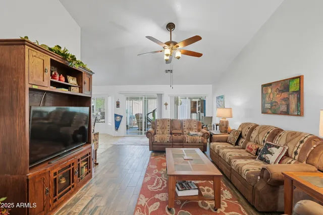 a living room with furniture a flat screen tv and a fireplace