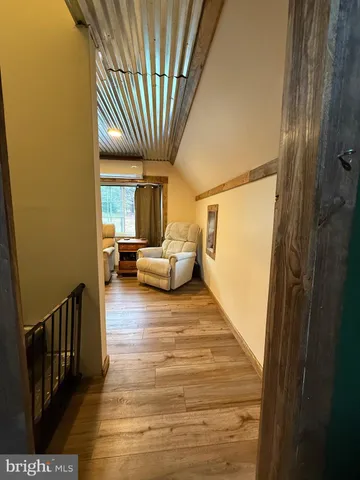 a view of a livingroom with wooden furniture