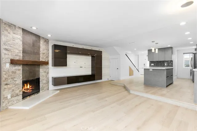 a view of kitchen with stainless steel appliances kitchen area and fireplace