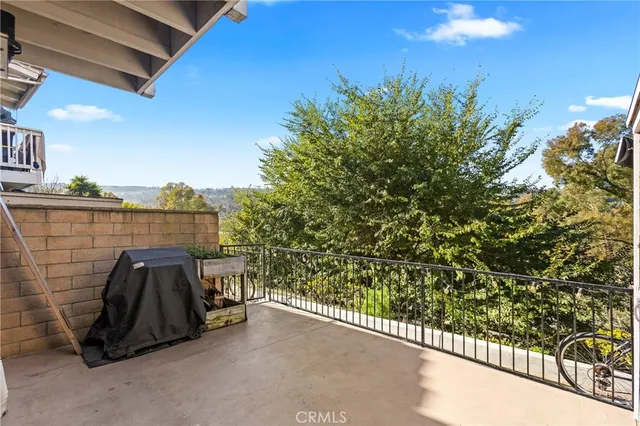 a view of balcony with two chair and a potted plant