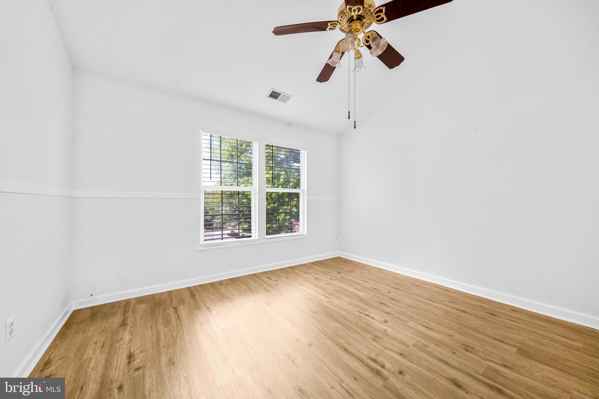 8596 Cold Harbor Loop Manassas, VA 20111 - Photo 21 of 52 an empty room with wooden floor chandelier fan and windows