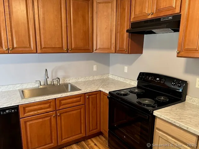 a kitchen with granite countertop cabinets and a stove top oven