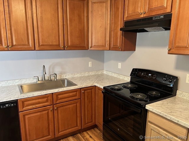 215 Sherman Avenue Hamden, CT 06518 - Photo 8 of 12 a kitchen with granite countertop cabinets and a stove top oven