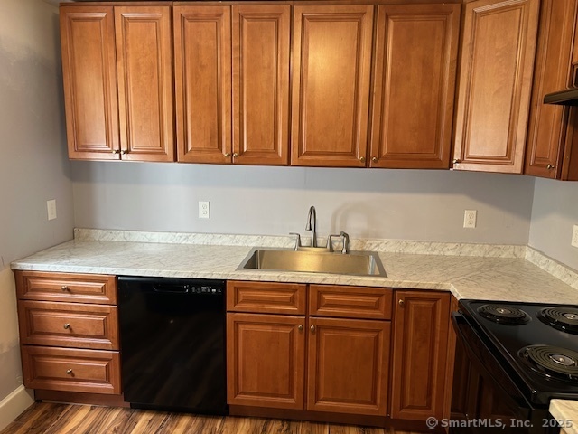 215 Sherman Avenue Hamden, CT 06518 - Photo 9 of 12 a kitchen with granite countertop cabinets and black appliances