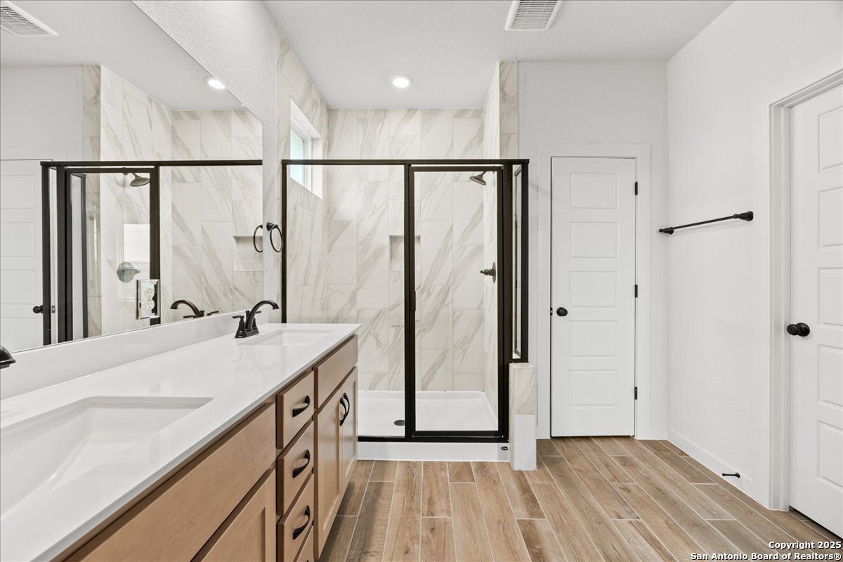 2009 Shepards Street Seguin, TX 78155 - Photo 14 of 22 a bathroom with a double vanity sink and a mirror