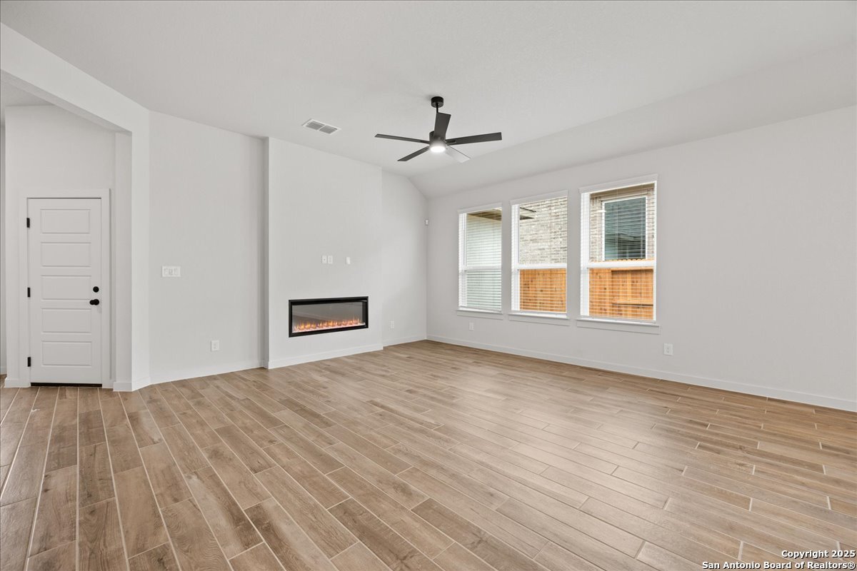 2009 Shepards Street Seguin, TX 78155 - Photo 4 of 22 a view of empty room with wooden floor and ceiling fan