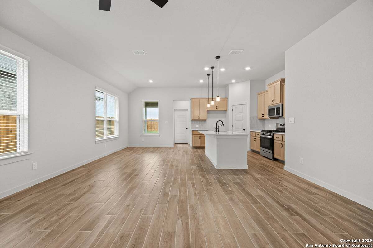 2009 Shepards Street Seguin, TX 78155 - Photo 9 of 22 a view of kitchen with wooden floor and electronic appliances