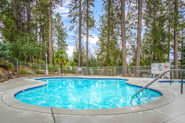 a kitchen with granite countertop a sink dishwasher stove and cabinets