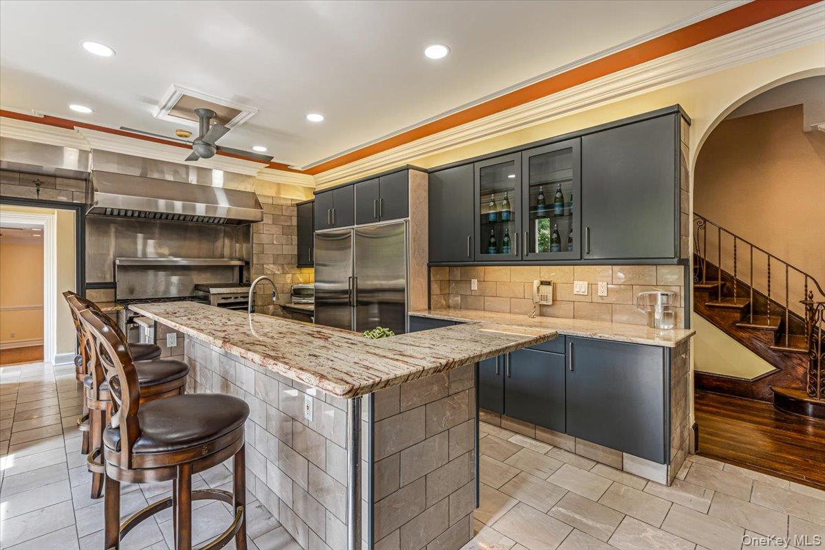 952 Cedar Swamp Road Glen Head, NY 11545 - Photo 19 of 50 a kitchen with a sink a stove and chairs