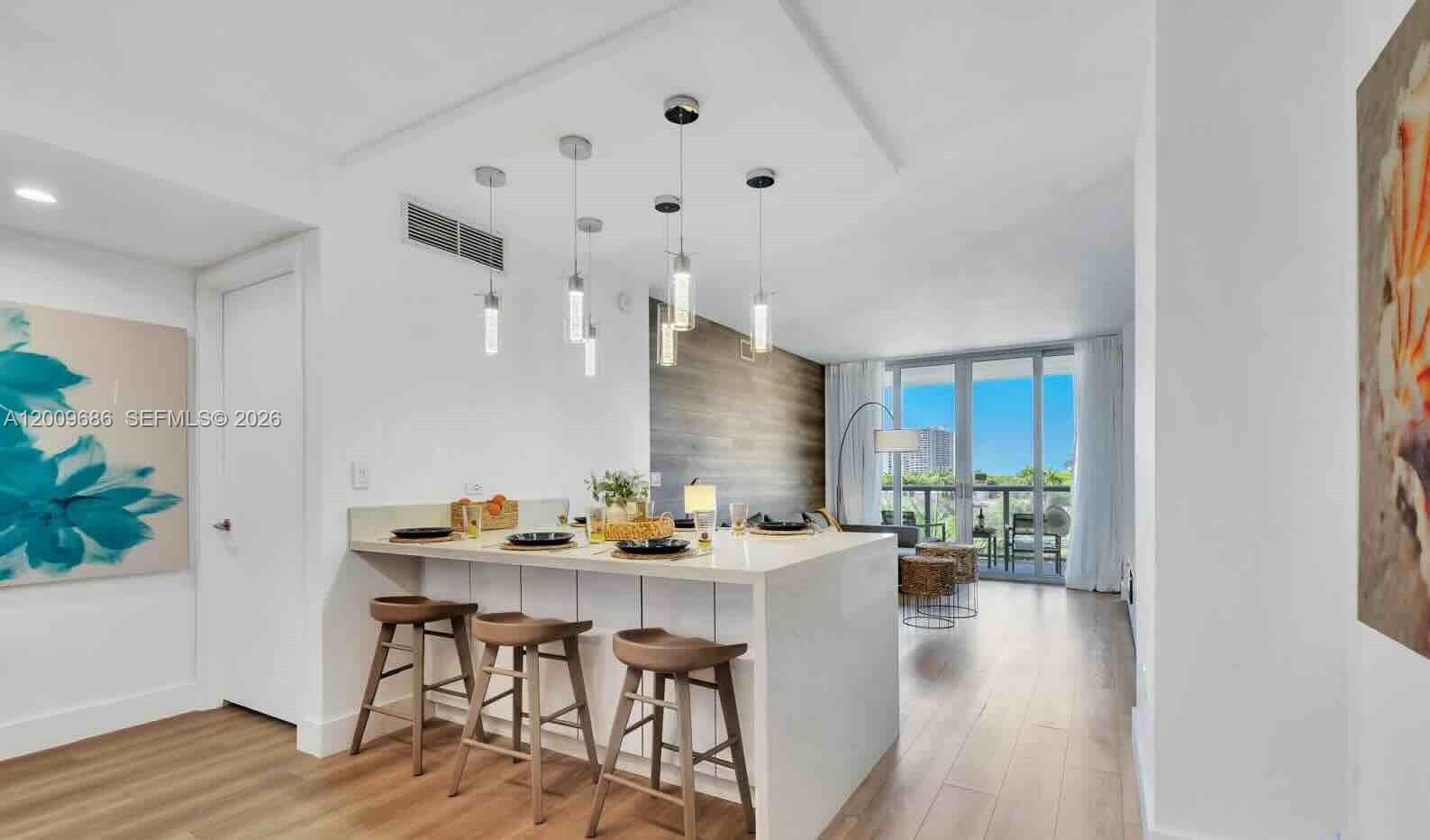 2602 East Hallandale Beach Boulevard, Unit R506 Hallandale Beach, FL 33009 - Photo 2 of 10 a dining room with furniture and wooden floor