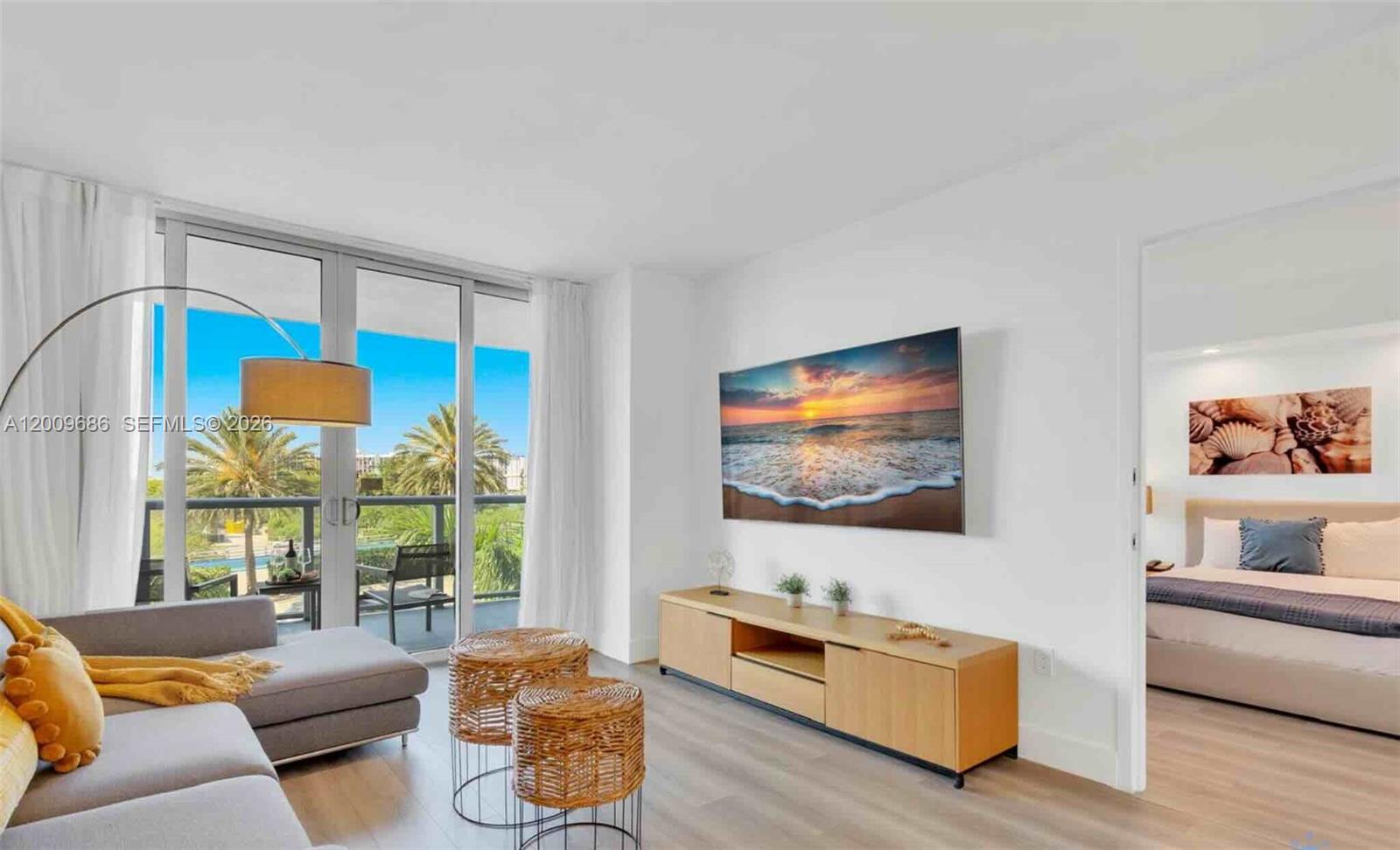 2602 East Hallandale Beach Boulevard, Unit R506 Hallandale Beach, FL 33009 - Photo 7 of 10 a living room with furniture and a flat screen tv