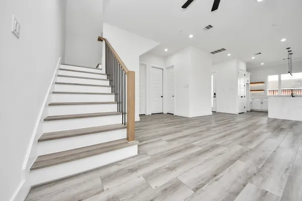 a view of entryway and hall with wooden floor