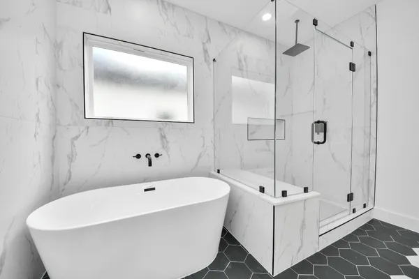 a bath tub sitting next to a white sink and a shower