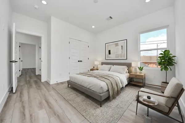 a spacious bedroom with a bed and a couch