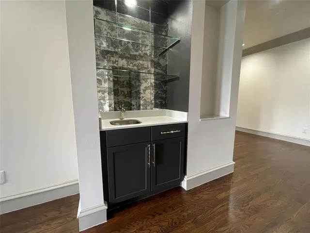 a kitchen with a sink and a mirror