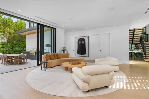 a living room with furniture and large windows