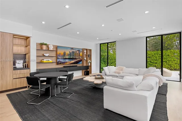 a kitchen with stainless steel appliances kitchen island granite countertop a refrigerator and a stove top oven