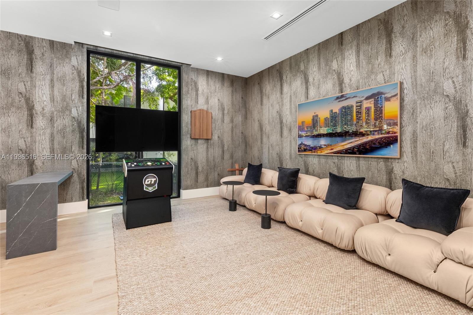 6003 Southwest 80th Street South Miami, FL 33143 - Photo 32 of 98 a living room with furniture a fireplace and a flat screen tv